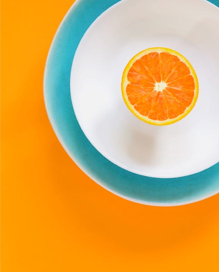 Fresh orange fruit slices on a plate